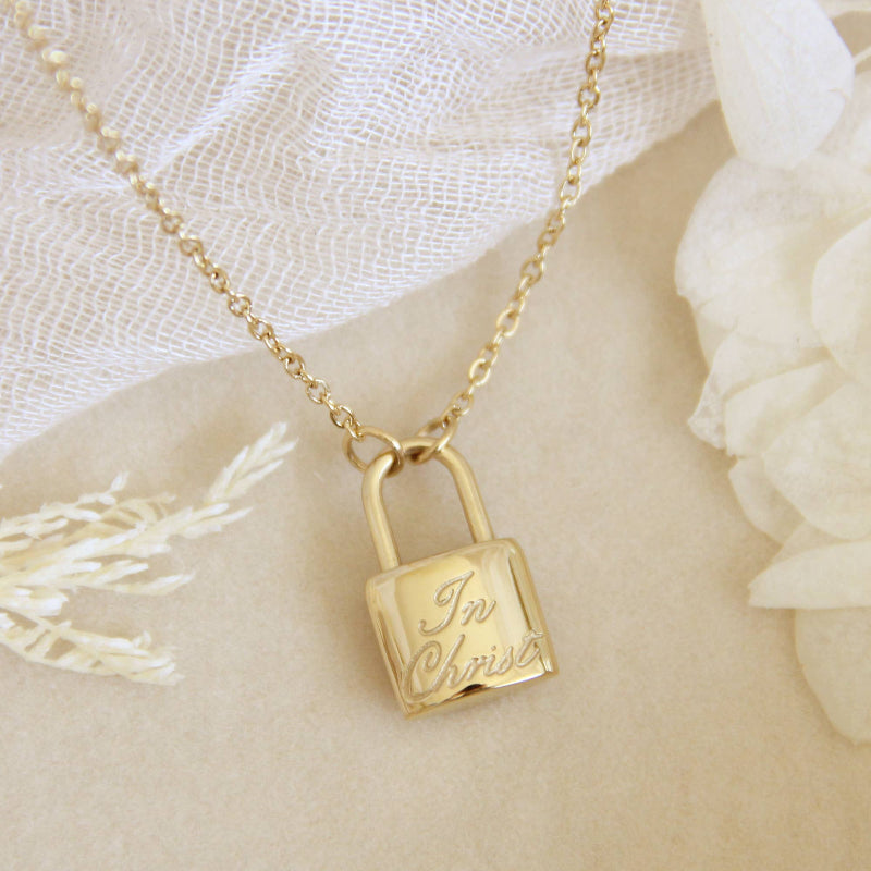 gold chain necklace with lock engraved with text &quot;In Christ&quot;. Necklace is a part of the Love Story collection by Maive