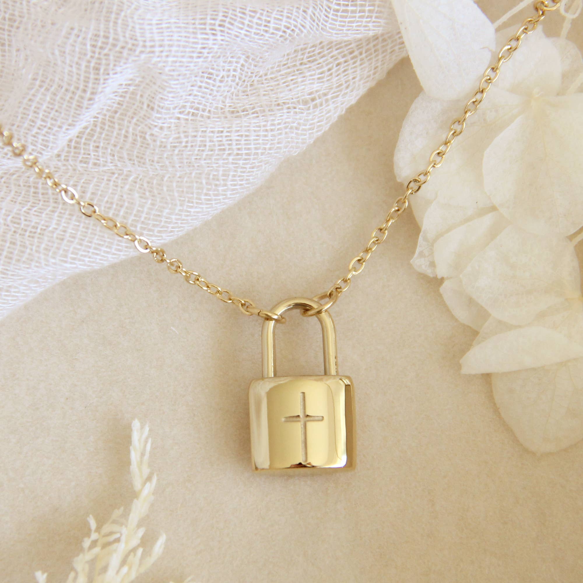 gold chain necklace with lock engraved with cross symbol. Necklace is a part of the Love Story collection by Maive