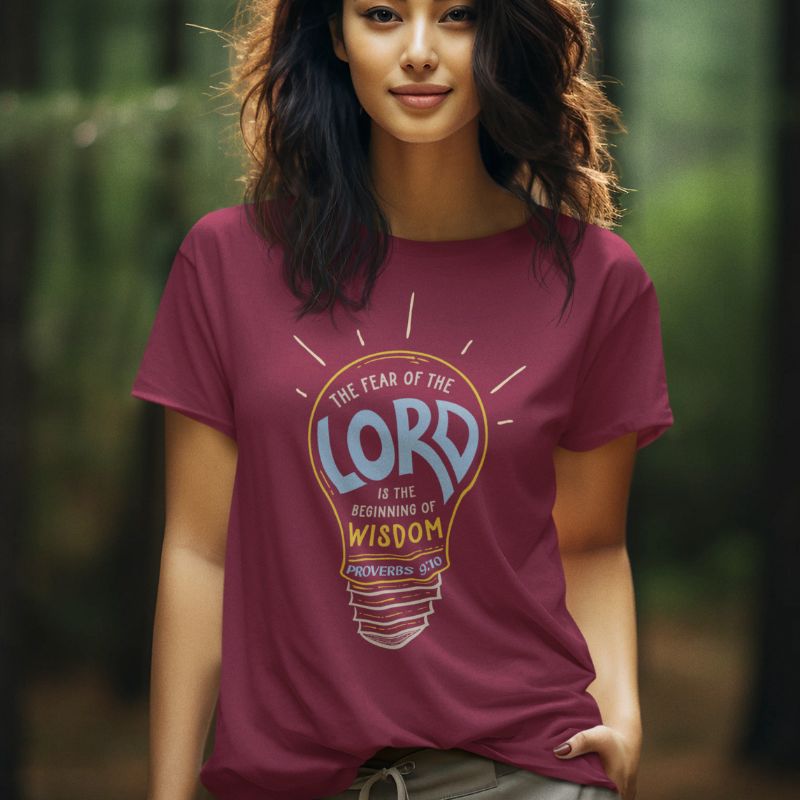 Asian woman wearing a maroon Christian shirt. The design is a lightbulb, with text inside, that says, &quot;The fear of the Lord is the beginning of wisdom - Proverbs 9:10&quot;