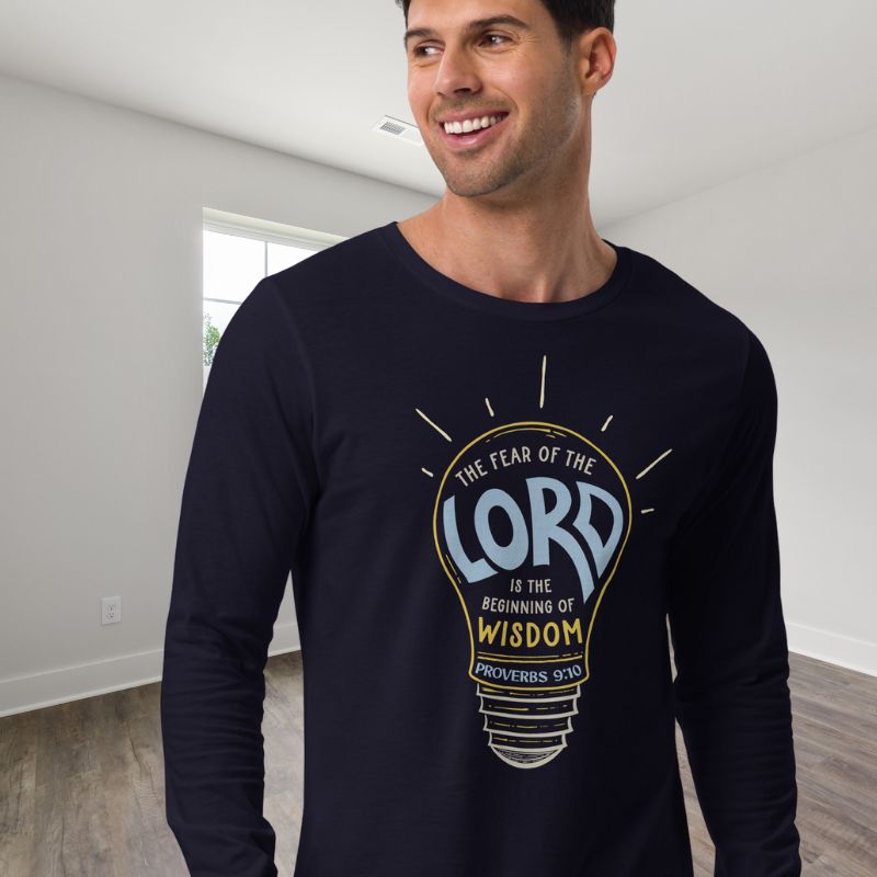 White man wearing a navy Christian long-sleeve shirt. The design is a lightbulb, with text inside, that says, &quot;The fear of the Lord is the beginning of wisdom - Proverbs 9:10&quot;