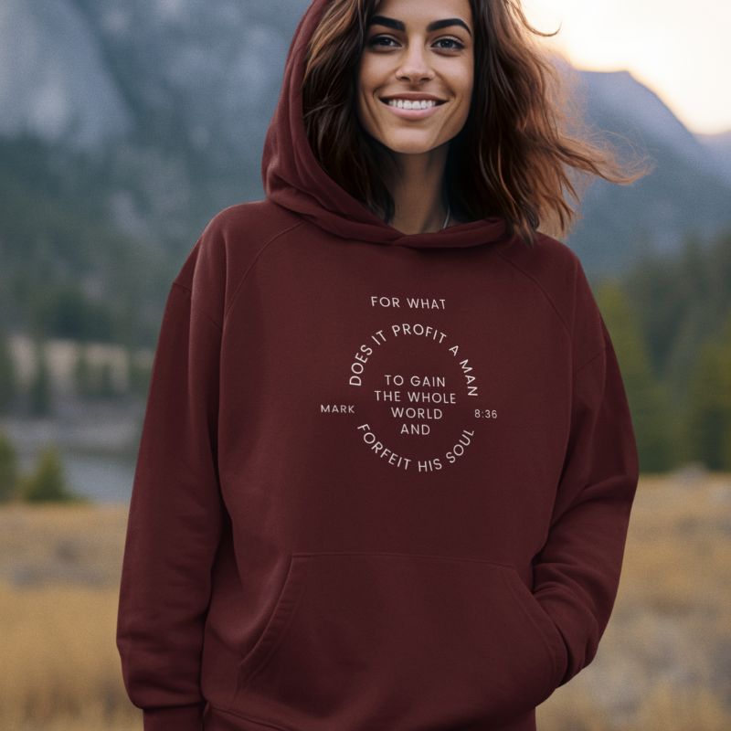 Indian woman wearing a maroon Christian hoodie that says &quot;For what does it profit a man to gain the whole world and forfeit his soul&quot; and the verse Mark 836 right in the middle