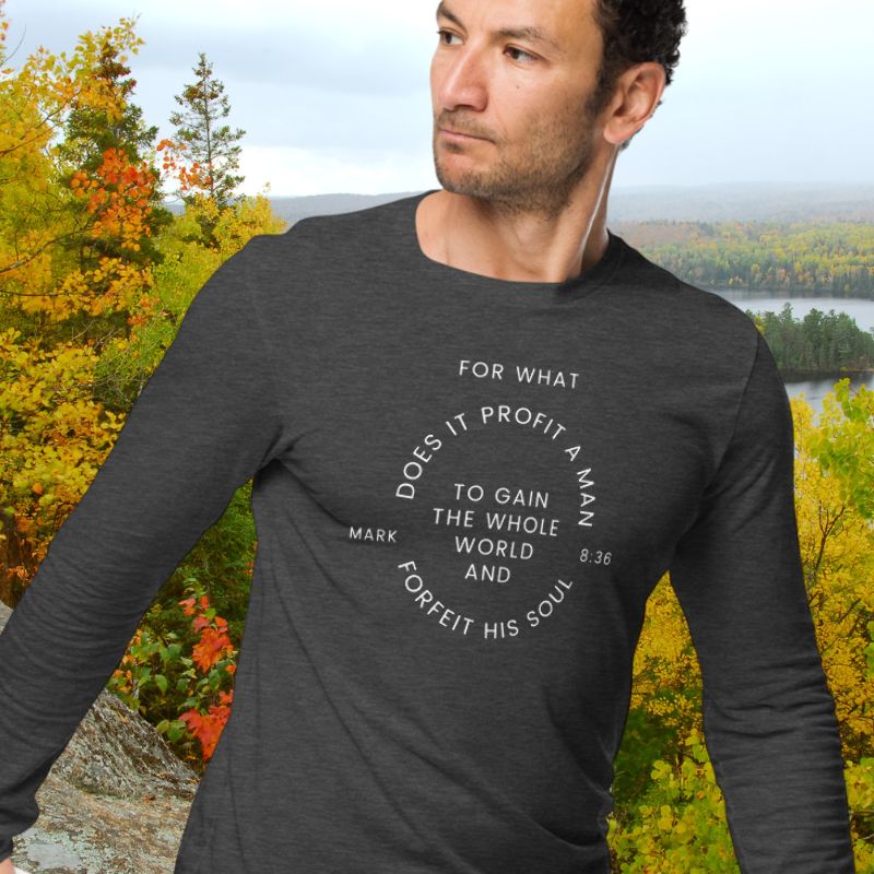 White man wearing a gray long sleeve shirt that says &quot;For what does it profit a man to gain the whole world and forfeit his soul - Mark 8:36&quot;

This shirt is sold at Amela&