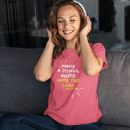 White woman listening to music while wearing and showcasing a pink Christian t-shirt that says &quot;Make joyful noise unto the Lord&quot; with &quot;Pslam 98:4 underneath&quot;. Surrounding the text, there are lines that show movement or music.