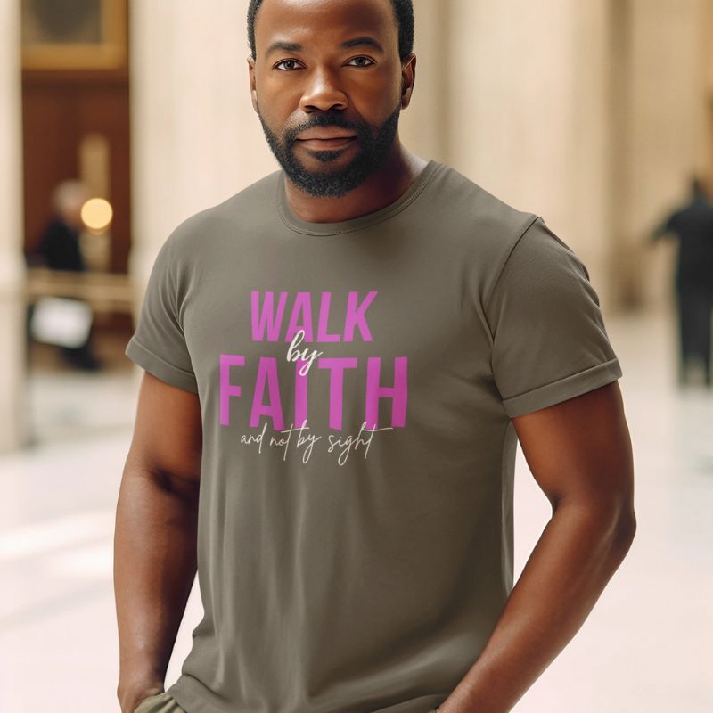 Black man wearing a gray Christian t-shirt that says &quot;Walk by faith, not by sight&quot;. The shirt is sold at Amela&