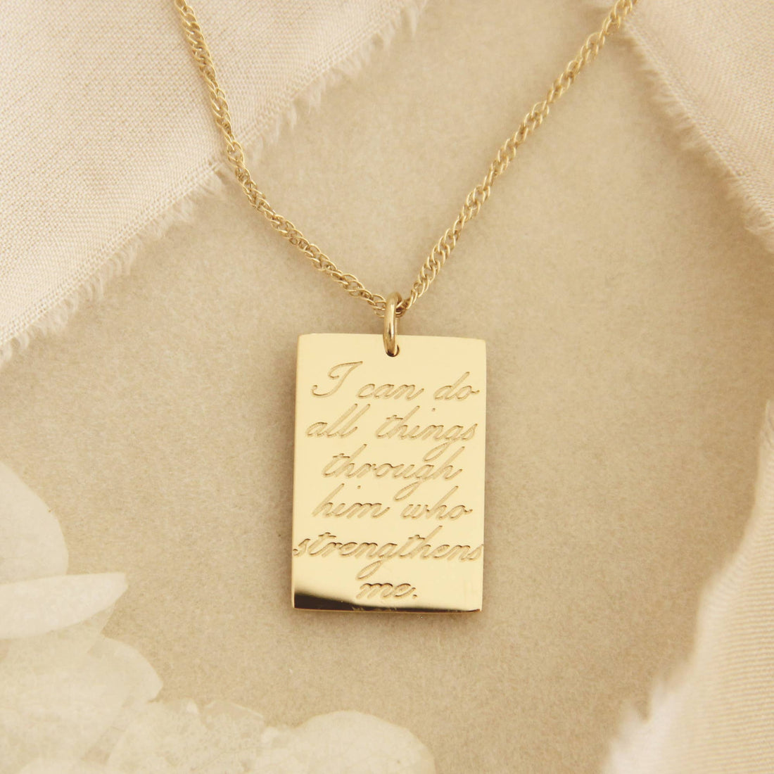 Gold chain necklace with a gold square pendant engraved with &quot;I can do all things through him who strengthen me&quot;, a verse of Philippians 4:13