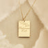 Gold chain necklace with a gold square pendant engraved with "Philippians 4:13" and some leaves