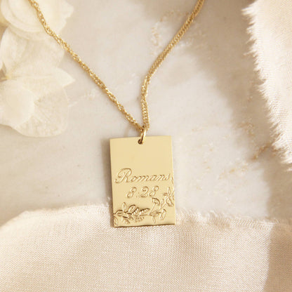 Gold chain necklace with a gold square pendant engraved with &quot;Proverbs 8:28&quot; and some leaves