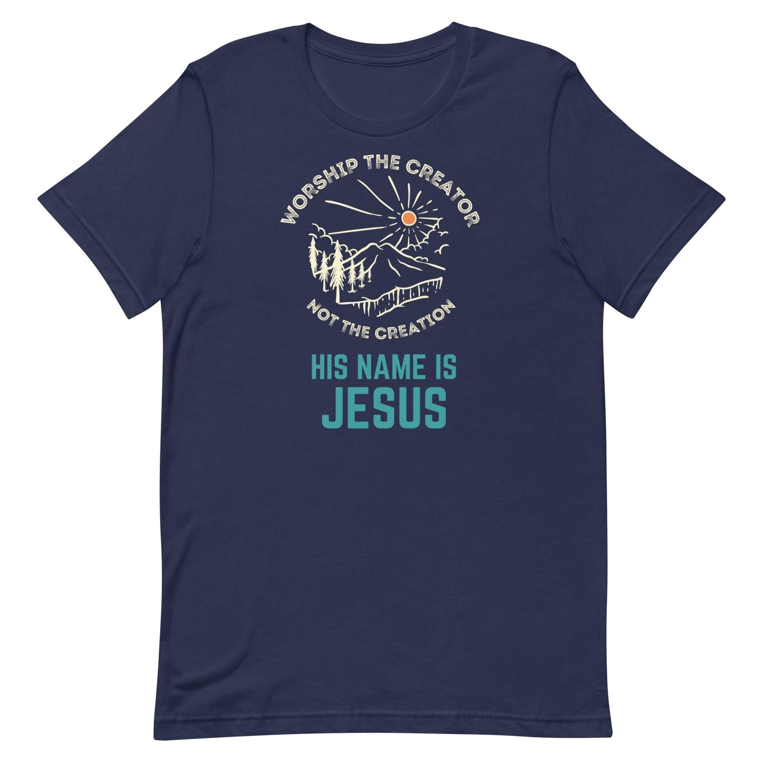 Flatlay of a blue Christian t-shirt. There is a graphic of a mountain, trees, and sun. Over the graphic, it says &quot;Worship the creator&quot;, and under it says &quot;not the creation&quot;. On the bottom, it says &quot;His name is Jesus&quot;. This shirt is sold at Amela&