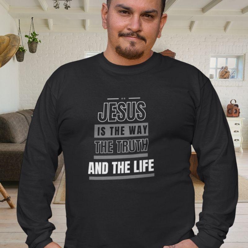 Hispanic man wearing a black Christian long-sleeve shirt. The shirt text reads &quot;Jesus is the way, the truth, and the life&quot;