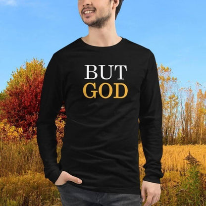 White man wearing black Christian unisex long-sleeve shirt that says &quot;BUT GOD&quot; in caps lock. 