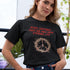 White woman wearing a black Christian t-shirt that says "Jesus suffered that we may have eternal life".

Below the text, there. is a graphic of a crown of thorns, with a cross in the middle. The crown of thorns was what Jesus wore on his head during the Crucifixion.