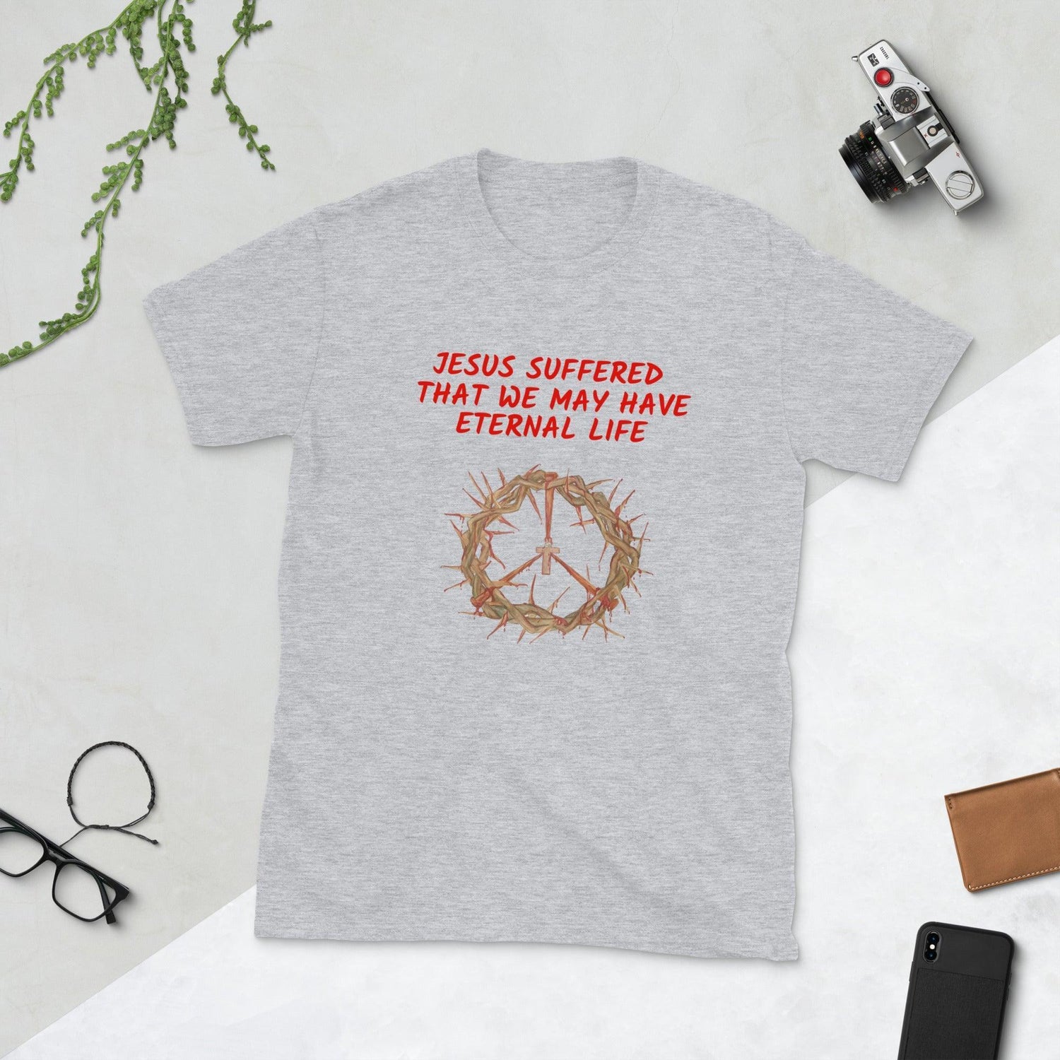 Flatlay of a gray Christian t-shirt that says &quot;Jesus suffered that we may have eternal life&quot;.

Below the text, there. is a graphic of a crown of thorns, with a cross in the middle. The crown of thorns was what Jesus wore on his head during the Crucifixion.