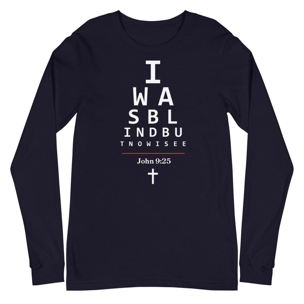 Flatlay of a long-sleeve navy Christian shirt.  

The graphic is text as an eye chart, and it says &quot;I WAS BLIND BUT NOW I SEE&quot;.

Below the text, there is a thin line, with text &quot;John 9:25&quot; and an icon of a cross below.